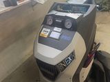 a machine that is sitting on the ground in the garage