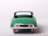 a green toy car with a white top on a white surface
