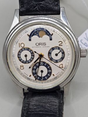 a close up of a wrist watch with a leather strap