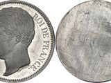 a close up of a coin on a white surface with a white background