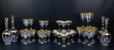 a lot of wine glasses and decanters on the table