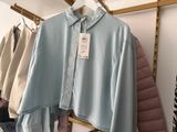 a blue shirt hanging on a rack in a room