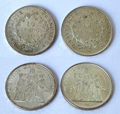 four different types of coins are shown on a white surface