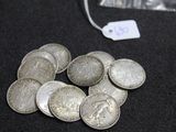 a pile of silver coins on a black surface