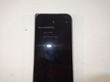 the back of a black cell phone with the screen showing accessibility