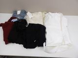 a white table with a bunch of clothes on top of it