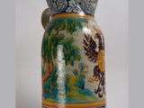 a large blue and yellow vase with a bird on it