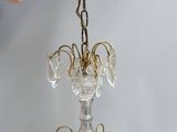 someone is holding a chandelier that is hanging from the ceiling