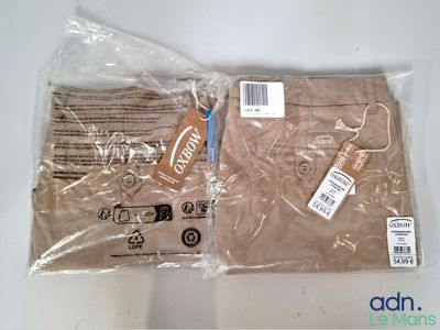two bags of clothing that are wrapped up on a table