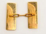 a gold plated letter h with a chain attached to it