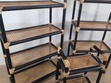 three black and wicker bookshelves are stacked on top of each other