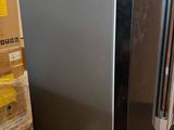 an image of a stainless steel refrigerator in a warehouse