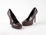 pair of brown snakeskin high heels on a white surface