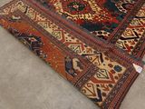 an image of a rug on the floor with a cat sitting on top of it