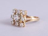 an image of a gold ring with a cluster of diamonds
