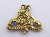 a close up of a gold plated metal object on a white surface