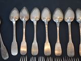 a lot of silver spoons and forks on a table