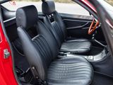 a red car with black leather seats in the back of it