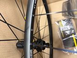 the front wheel of a bicycle with a black rim and a black spoke