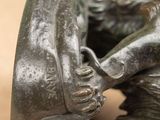 a bronze statue of a horse and a dog on a table