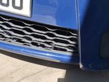a close up of a blue car with a number plate on it