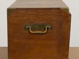 an old wooden box with a metal handle on a table