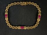 un bracelet en or orné de pierres roses sur fond noir