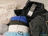 a pile of clothing that is sitting on a couch