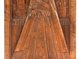 a wooden plaque with a woman in a dress on it