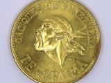 gold coin with a portrait of a woman on it