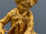 a gold statue of a man sitting on a horse