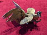 a bird that is sitting on a red cloth