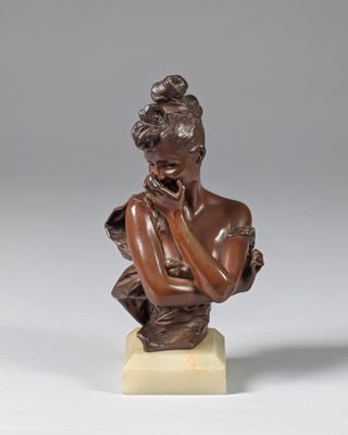 a bronze bust of a woman with her hand on her chin