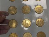 a person holding a piece of gold coins in their hand