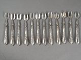 six silver plated forks and spoons are lined up on a table