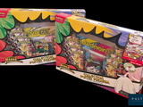 two boxes of pokemon trading cards on a black background