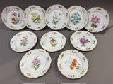 many plates with different designs on them on a table