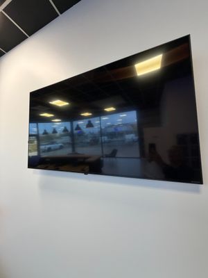 a flat screen tv mounted on the wall in a room