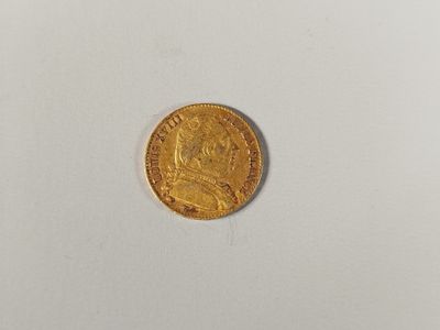 a close up of a gold coin on a white surface