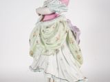 a figurine of a woman in a green dress