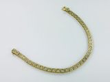 a close up of a diamond bracelet on a white surface