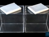 deux pains de savon dans une boîte transparente sur fond noir