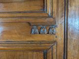 a close up of a door handle on a wooden door