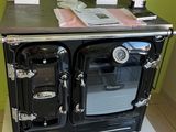 an old fashioned stove in a kitchen with a lot of papers on top of it