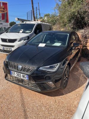 a black car parked in a parking lot next to a white car