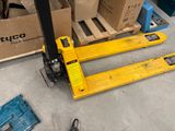 a fork lifter sitting on the floor in front of boxes