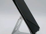 a cell phone that is sitting on a metal stand