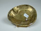 an image of a gold plate with a tag on it