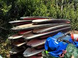 a pile of surfboards and other items in the back of a truck