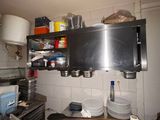a kitchen with a lot of pots and pans on the counter
